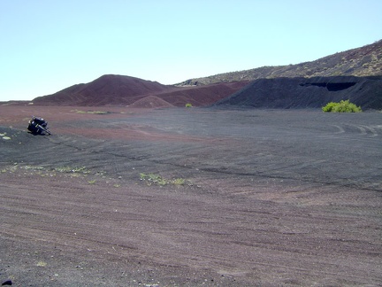 I return to the 10-ton bike and ride southwest across the red earth away to exit the Aiken Mine area