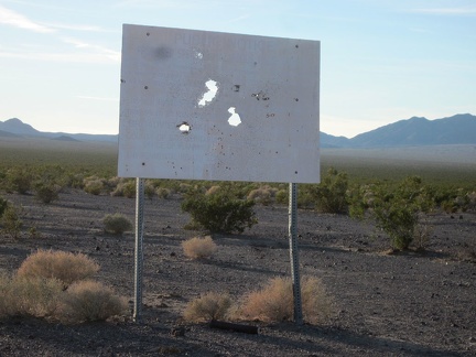 An old sign announcing a proposed toxic waste dump here at Broadwell Dry Lake has been appropriately well shot-up