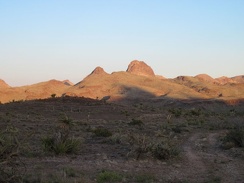 The nearby Castle Mountains and Hart Peak radiate in the sunset near Malpais Spring