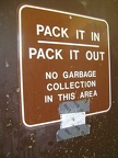 Despite the standard-issue sign on the outhouse at Coit Lake, there is in fact a trash can here